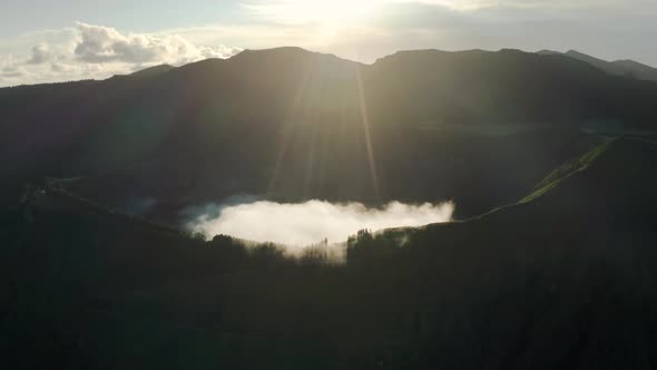 Sun Rays Breaking Through Clouds and Lighting Lake Azul in Morning Azores