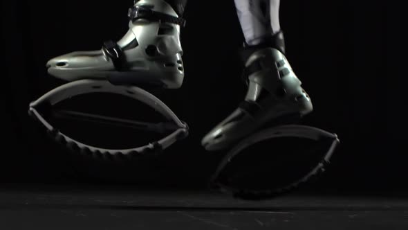 Legs Doing Exercises in Kangoo Jumps. Slow Motion. Close-up