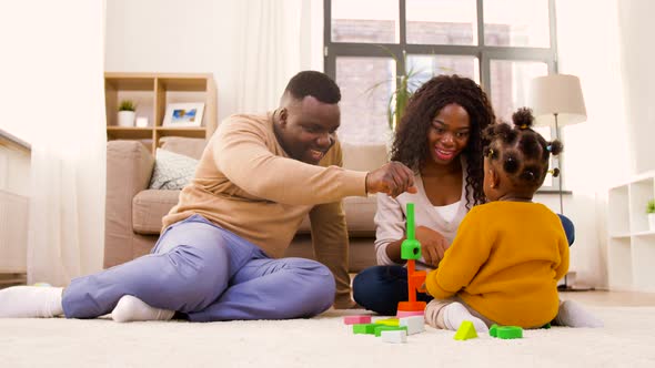 African Family Playing with Baby Daughter at Home