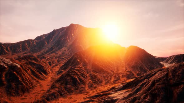 Sun Rays Over Mountains in a Valley