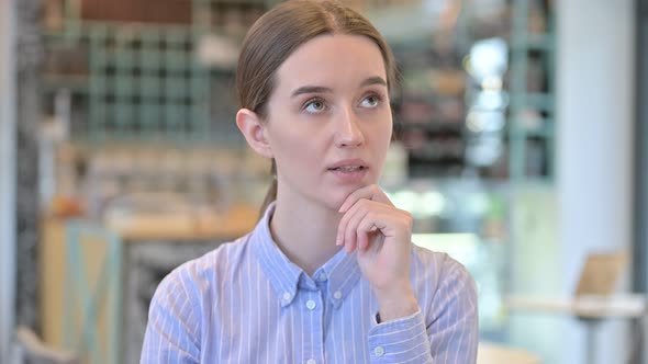 Portrait of Pensive Young Businesswoman Thinking 