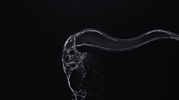 Water splash in midair against black background. Slow Motion. Unedited version included.