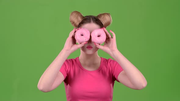 Teen Holds Cake in Her Hands and Closes Her Eyes. Green Screen. Slow Motion