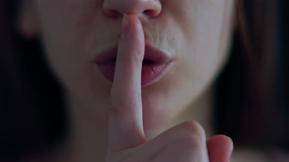 Close Up of a Caucasian Woman Portrait Doing Silence Gesture with Finger