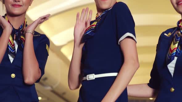 Cabin Crew Dancing with Joy in Airplane