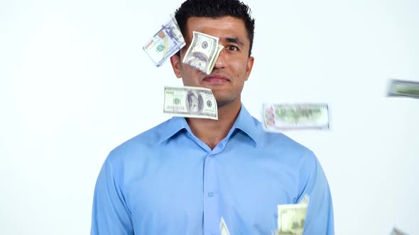 Slow Motion of Arab Man Standing on a White Background and a Lot of Dollar Bills are Suddenly Thrown