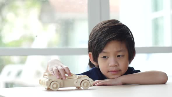 Cute Asian Child Playing Wood Model Cars Slow Motion