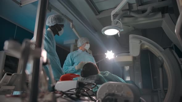 Diverse Doctors Examining Screen During Surgery