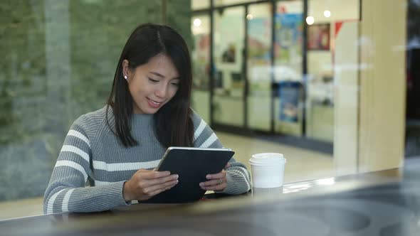 Young woman use digital tablet in coffee shop