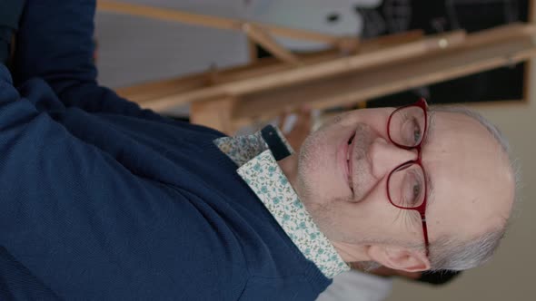 Vertical Video Portrait of Senior Man Enjoying Art Class to Develop Drawing Skills alt