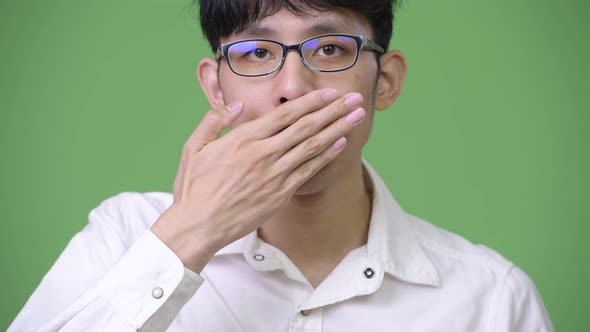 Young Asian Businessman Covering Mouth As Speak No Evil Concept