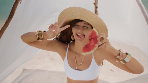 Woman on the Tropical Beach Eating Watermelon