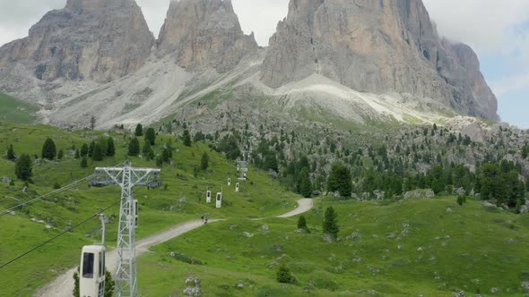 Cable car lifts hikers to summit at rocky mountain, Dolomites, Tyrol