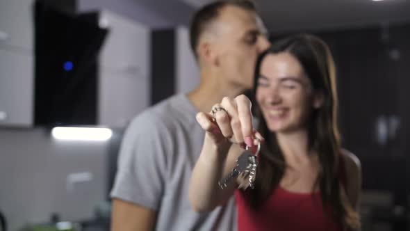 Excited Smiling Couple Shaking Home Keys