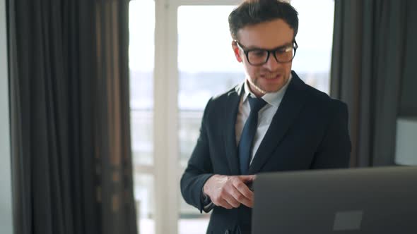 Caucasian Man Dressed in a Jacket and Underwear Using Laptop To Make a Video Call From Home in a