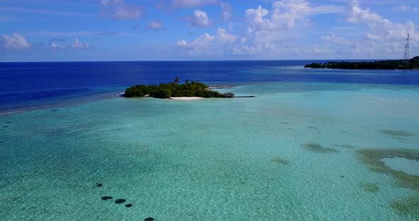 Daytime flying clean view of a white sand paradise beach and aqua blue ocean background in colourful