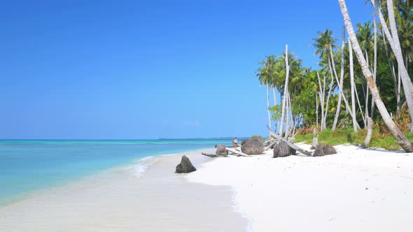 Slow motion: adult mature woman walking on tropical beach turquoise water caribbean sea