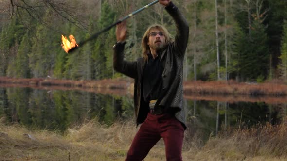 Excited Male Dancer Dancing with Fire Stick