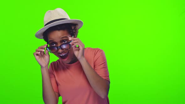 Young Overjoyed African American Woman in Hat and Sunglasses Rejoices at Meeting