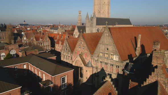 Historic buildings near Church of Our Lady line a canal in Bruges