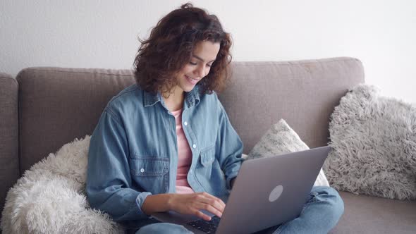 Smiling Latin Young Woman Freelancer Working Online on Computer Laptop