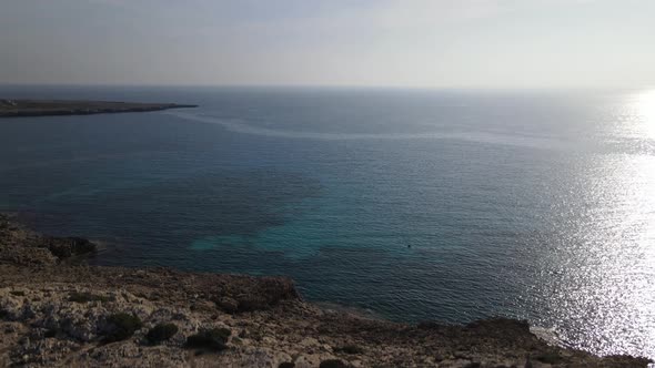 Mediterranean Sea stretching into the distance. Take off the camera over the sea.