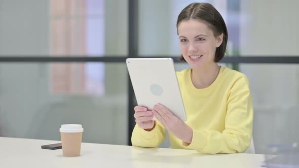Young Woman Making Video Call on Tablet in Office