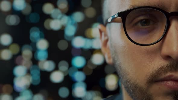 Close-up portrait of a young man working at the computer.