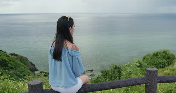 Woman enjoy the sea view at ishigaki island