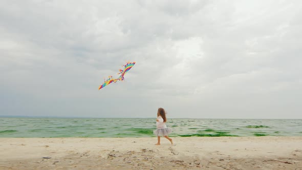 Little Girl Playing with Kite on the Beach