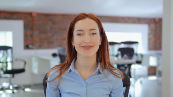 Redhead Businesswoman Shows Sign Like at Work