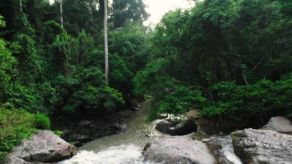 Drone flying downwards along hin lat waterfall