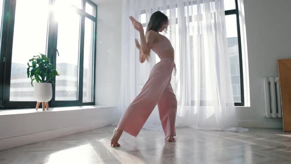 Modern Dancing  Young Slim Woman Dances in White Spacious Room