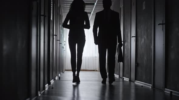 Silhouettes of Man and Woman Walking