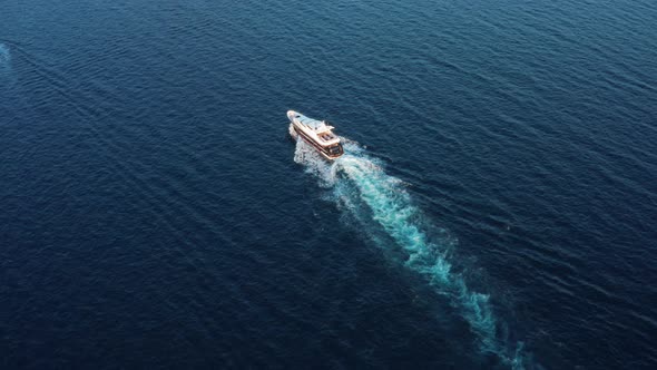 The Lonely White Yacht Floats in the Open Dark Blue Sea