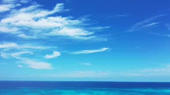 Natural birds eye island view of a paradise sunny white sand beach and aqua blue water background in