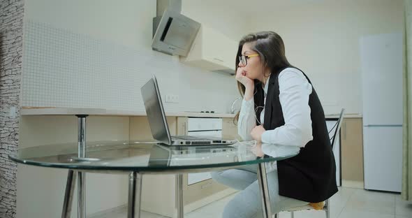 Lady in Classic Vest and Sportive Pants at Online Conference