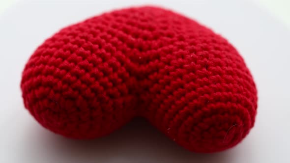 Red Heart Tied From Wool Rotates in a Circle