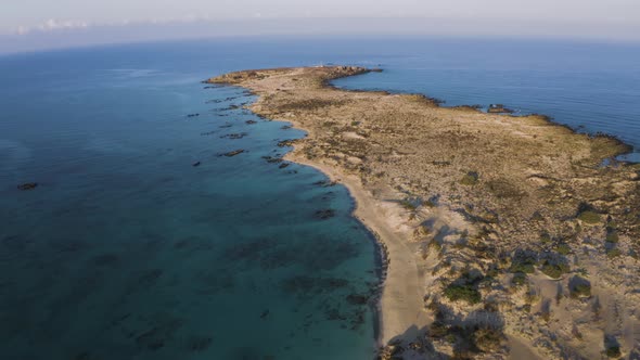 Aerial drone view of Rocky Island. Flyover Elafonisi beach in Crete, Greece. Seascape 