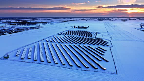 Snowy photovoltaic farm in winter. Alternative energy in Poland.