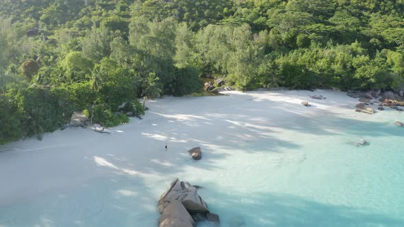 Aerial view of a person walking on the beach of Anse Lazio, Seychelles.