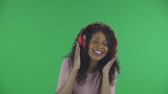 Portrait of Beautiful African American Young Woman Is Looking at Camera and Dancing and Enjoying