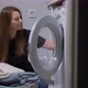 Woman Opens Door of Washing Machine Puts in Dirty Clothes and Takes Out Clothes - VideoHive Item for Sale