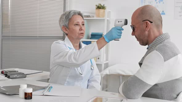 Doctor Checking Temperature of Patient