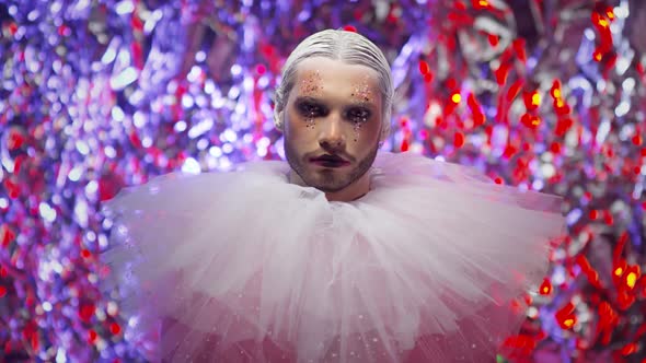 Man in Clown Couture Look Posing against Vibrant Background