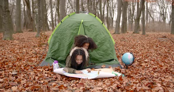 Black Girls Looking at Map in the Autumn Forest