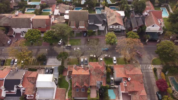 Cars driving along Parana Avenue crossing neighborhood of Vicente Lopez residential area in Buenos A