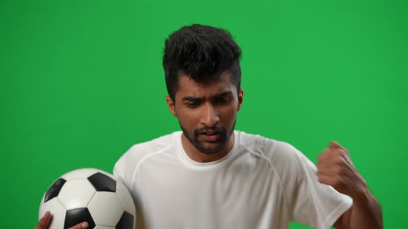 Portrait of Worried Dissatisfied Middle Eastern Man with Football Ball Talking Gesturing Looking at