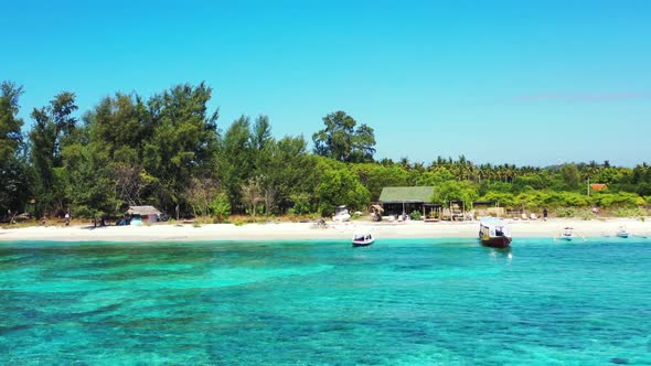 Aerial flying over tourism of tropical resort beach wildlife by transparent water with white sandy b