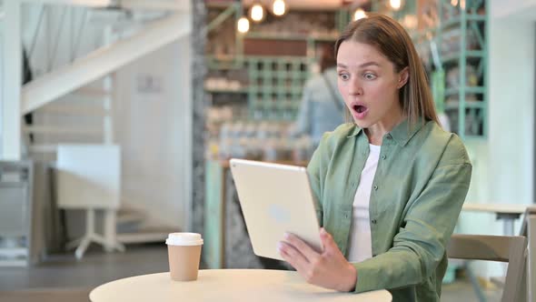 Upset Young Woman Reacting to Loss on Tablet